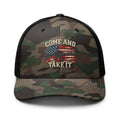 Front view of camouflage trucker hat with black mesh back, Come and Take It lettering, American flag and rifle artwork