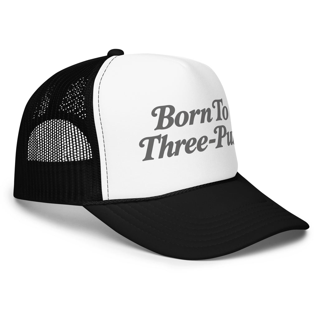 Angled front view of foam trucker hat, white with black brim and mesh back, featuring Born to Three-Putt script lettering