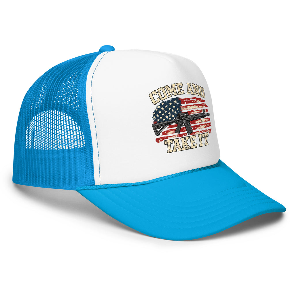 Angled front view of foam trucker hat, white with blue brim and mesh back, with Come and Take It lettering, American flag and rifle artwork