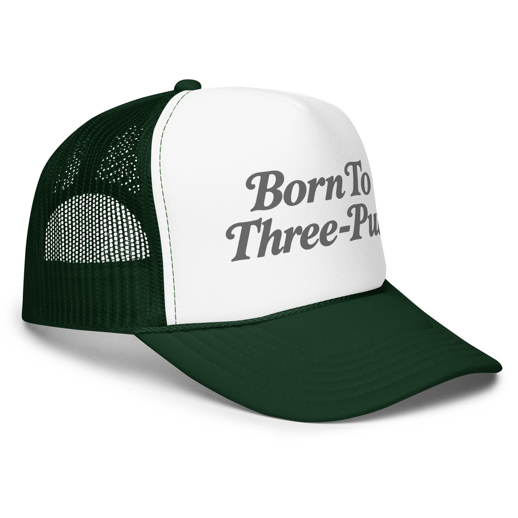 Angled front view of foam trucker hat, white with dark green brim and mesh back, featuring Born to Three-Putt script lettering