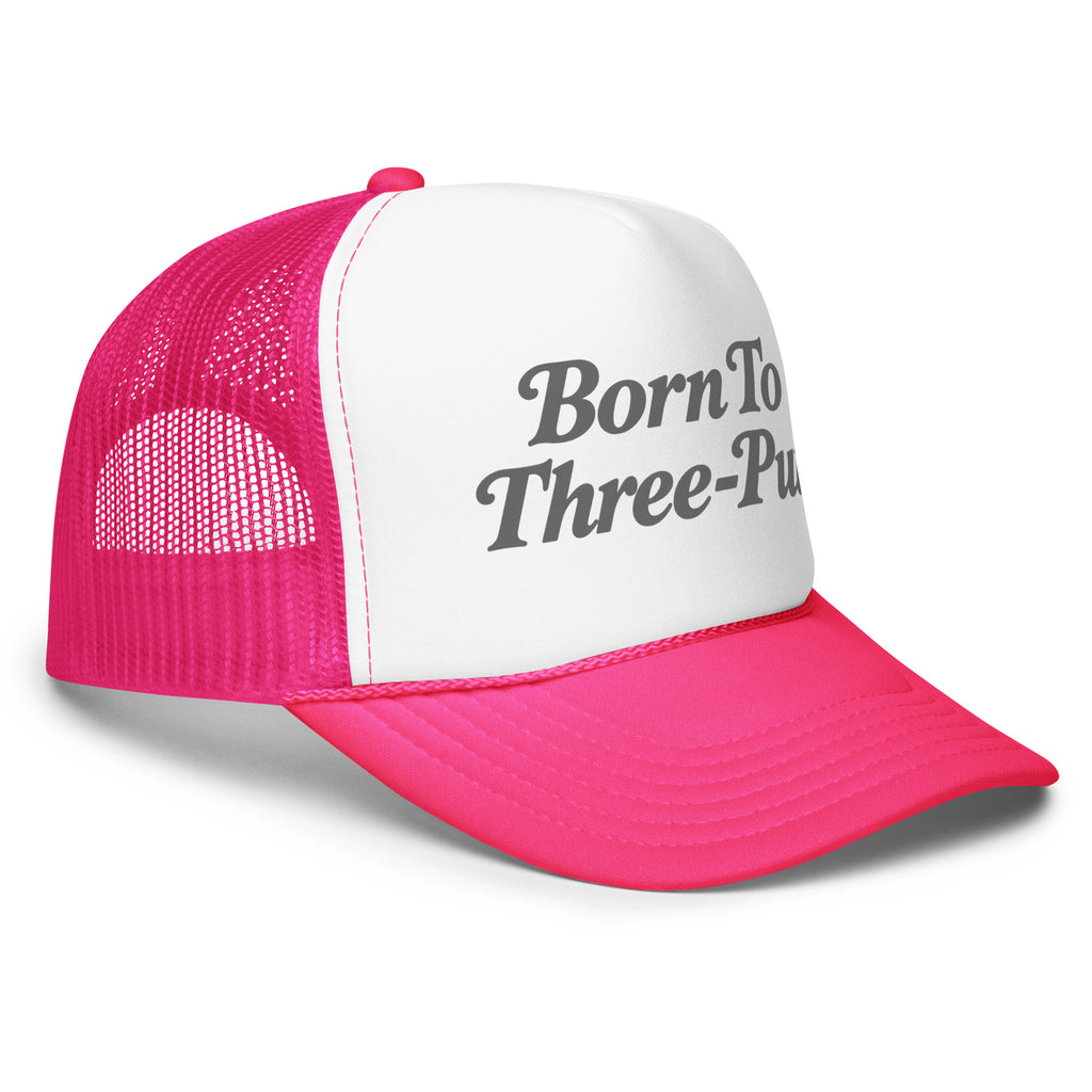 Angled front view of foam trucker hat, white with hot pink brim and mesh back, featuring Born to Three-Putt script lettering