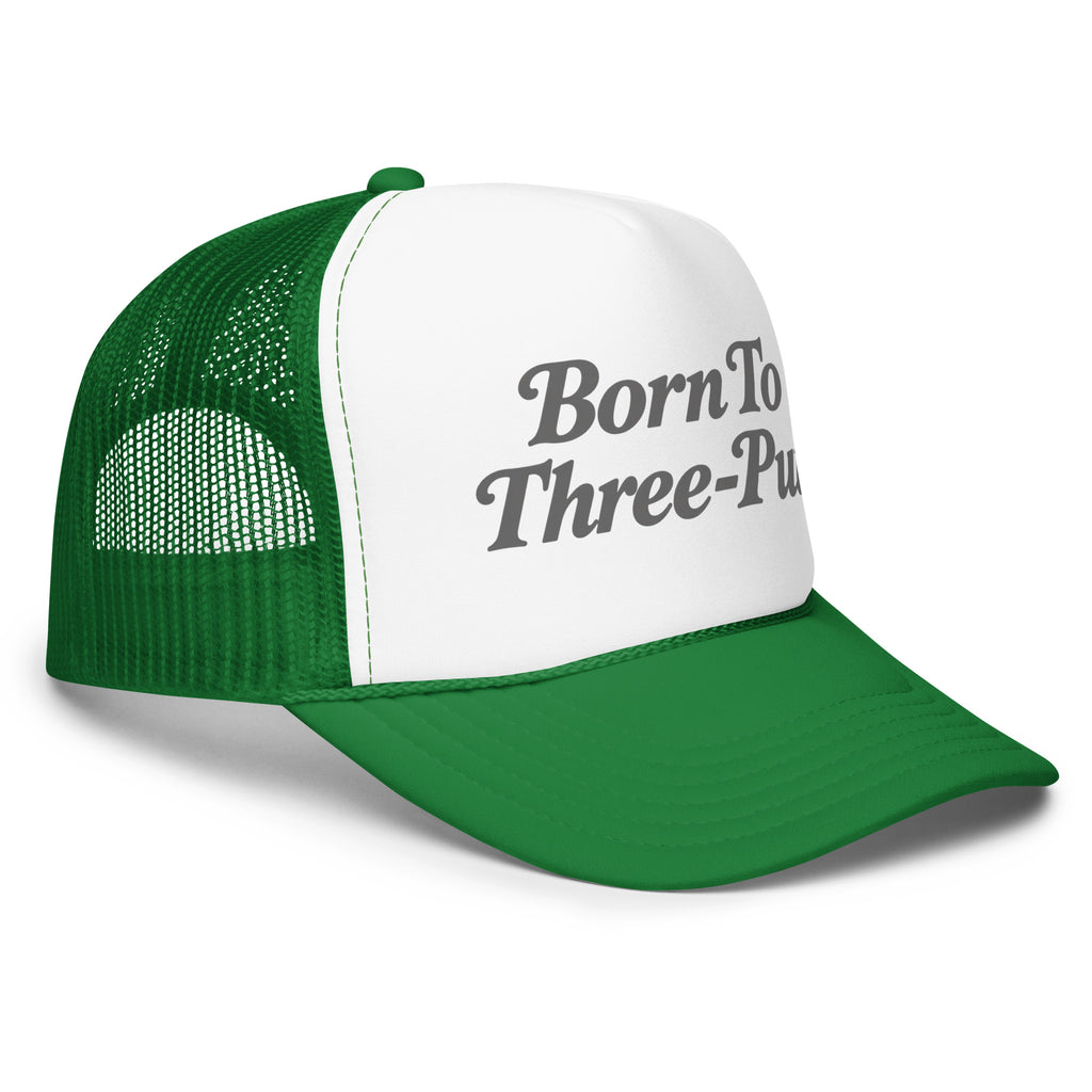 Angled front view of foam trucker hat, white with kelly green brim and mesh back, featuring Born to Three-Putt script lettering