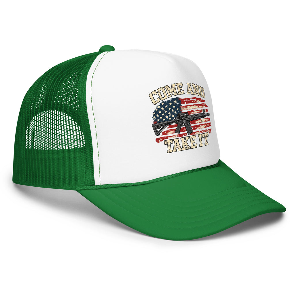 Angled front view of foam trucker hat, white with kelly green brim and mesh back, with Come and Take It lettering, American flag and rifle artwork