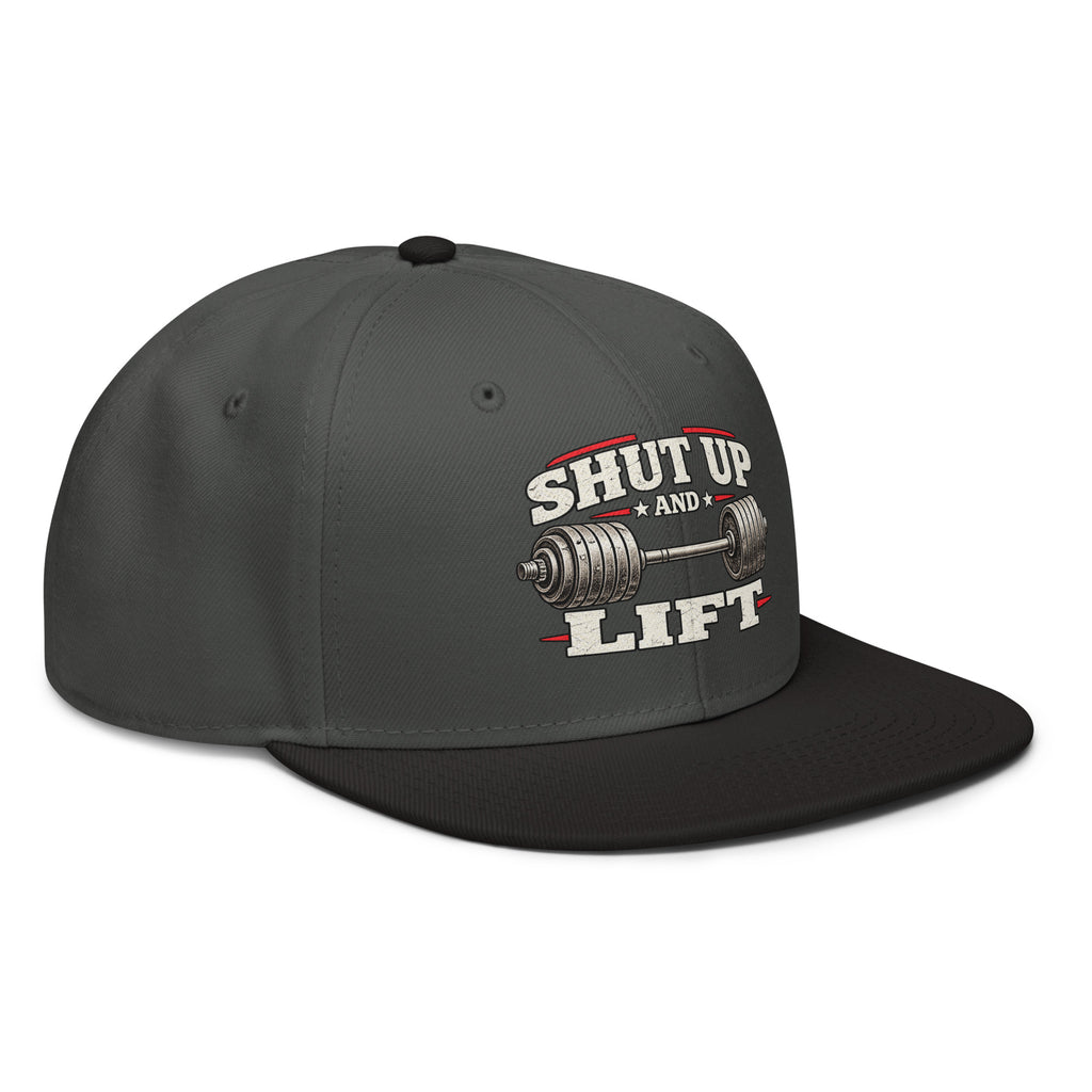 Angled front view of snapback hat, charcoal grey with black visor, featuring Shut Up and Lift lettering and a barbell graphic