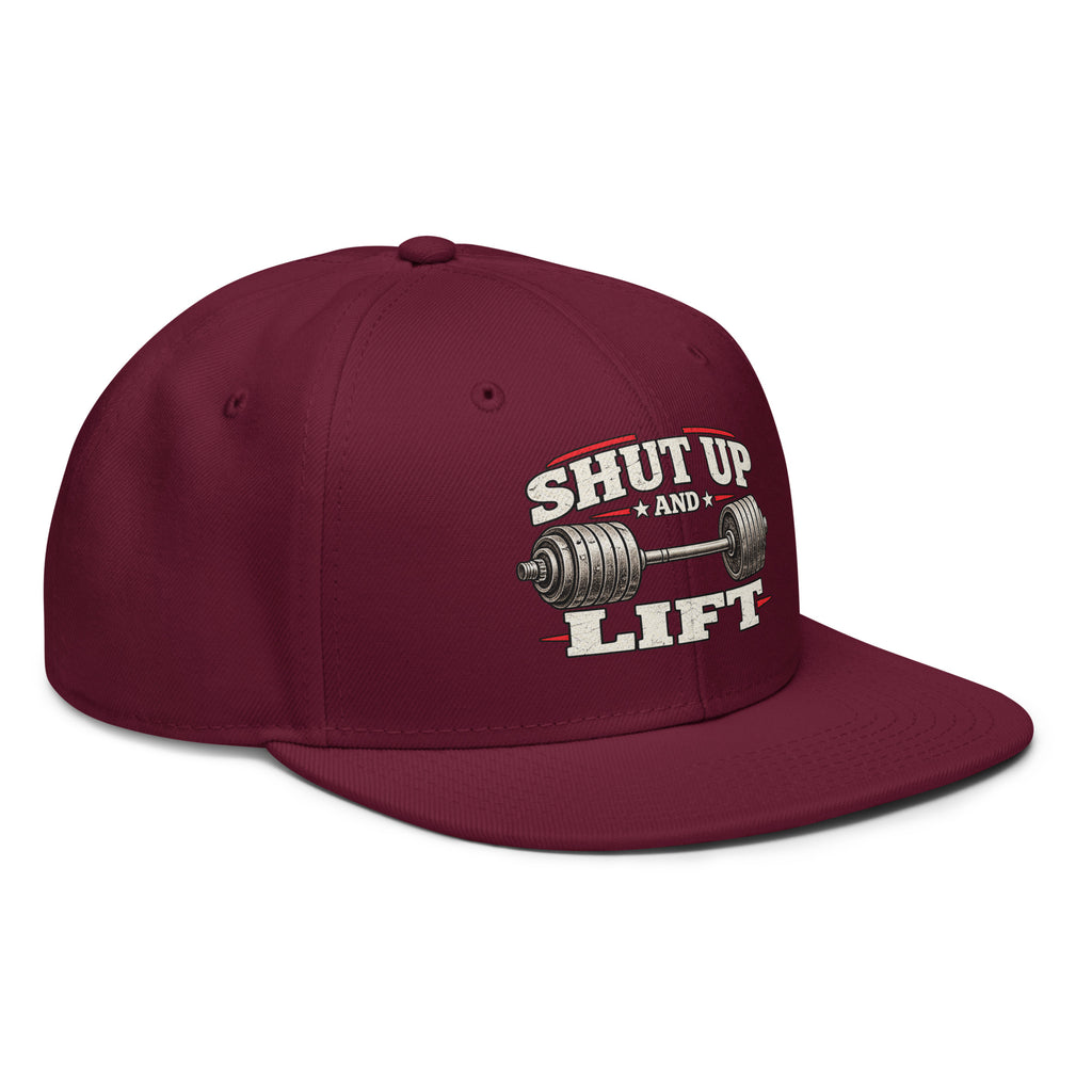 Angled front view of snapback hat, burgundy, featuring Shut Up and Lift lettering and a barbell graphic