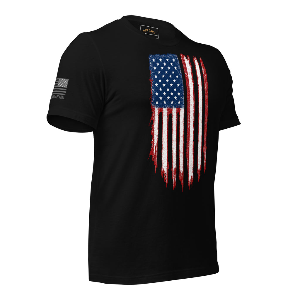 Angled front view of black T-shirt with a distressed red, white and blue American flag chest graphic and a smaller sleeve flag