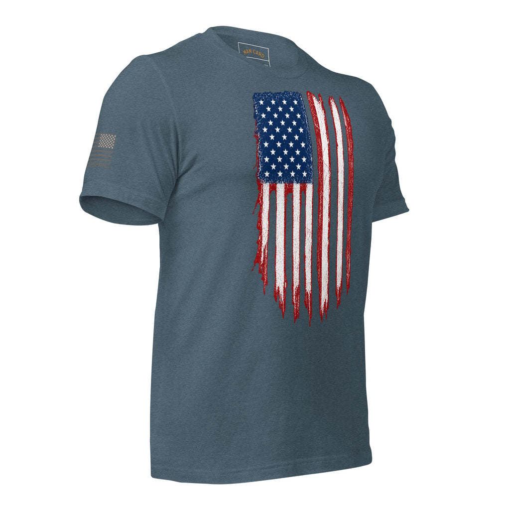 Angled front view of heather slate T-shirt with a distressed red, white and blue American flag chest graphic and a smaller sleeve flag