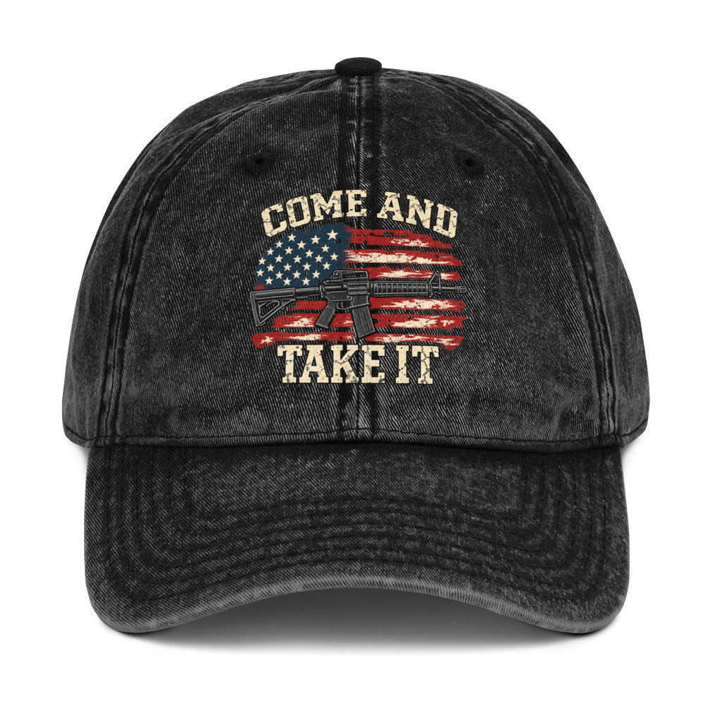 Front view of washed black vintage cap with Come and Take It lettering, American flag artwork and a rifle illustration
