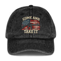 Front view of washed black vintage cap with Come and Take It lettering, American flag artwork and a rifle illustration