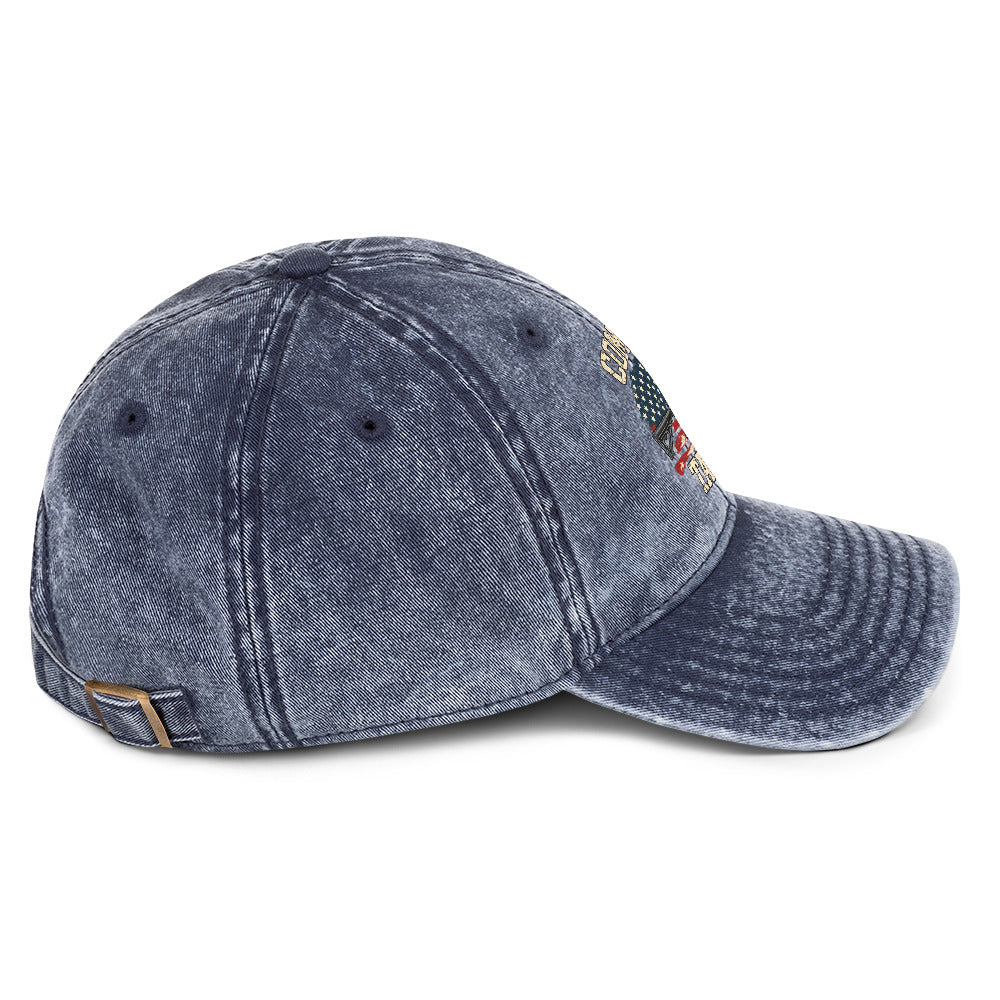 Right-side view of washed navy vintage cap with Come and Take It lettering, American flag artwork and a rifle illustration
